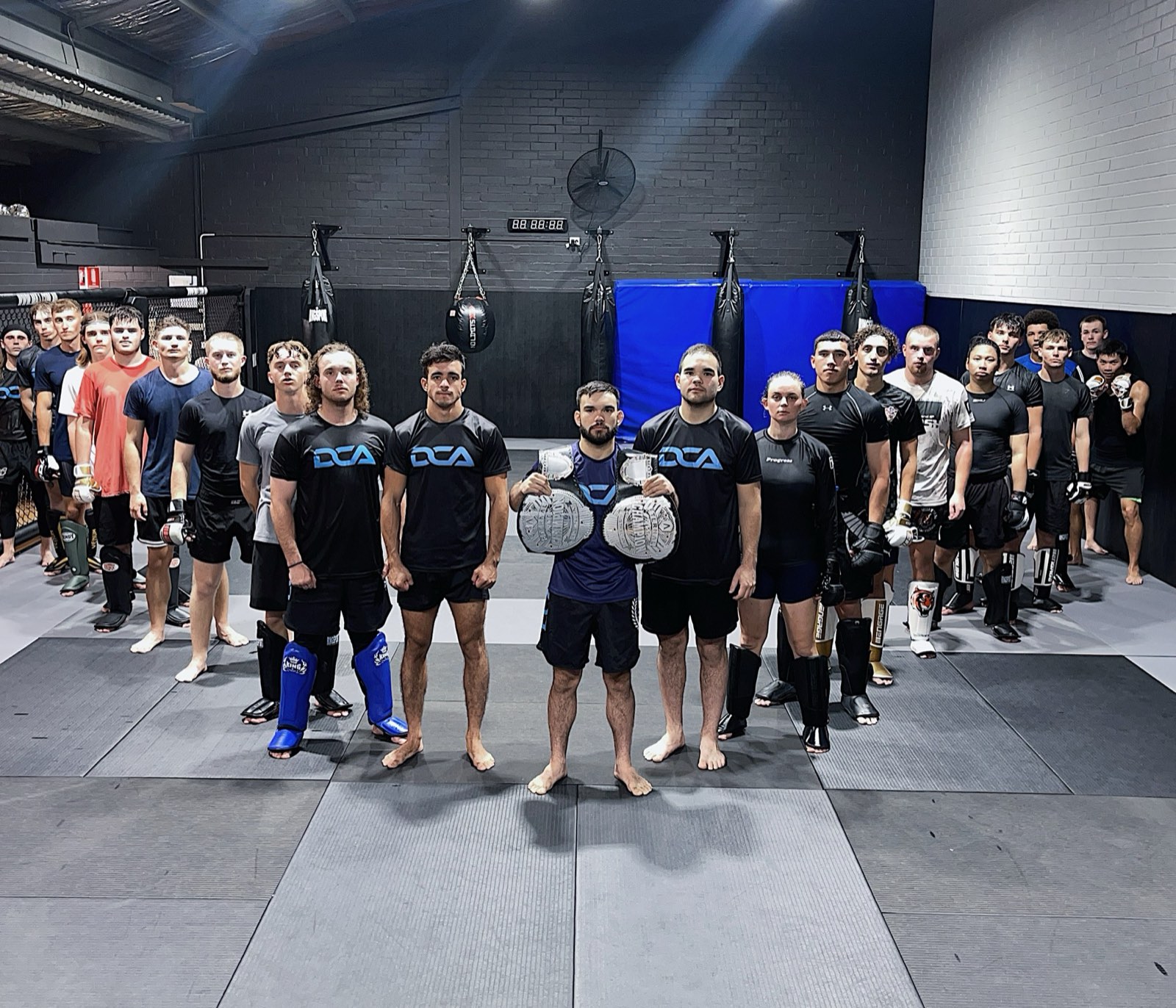 The DCA team on the mats with championship belts