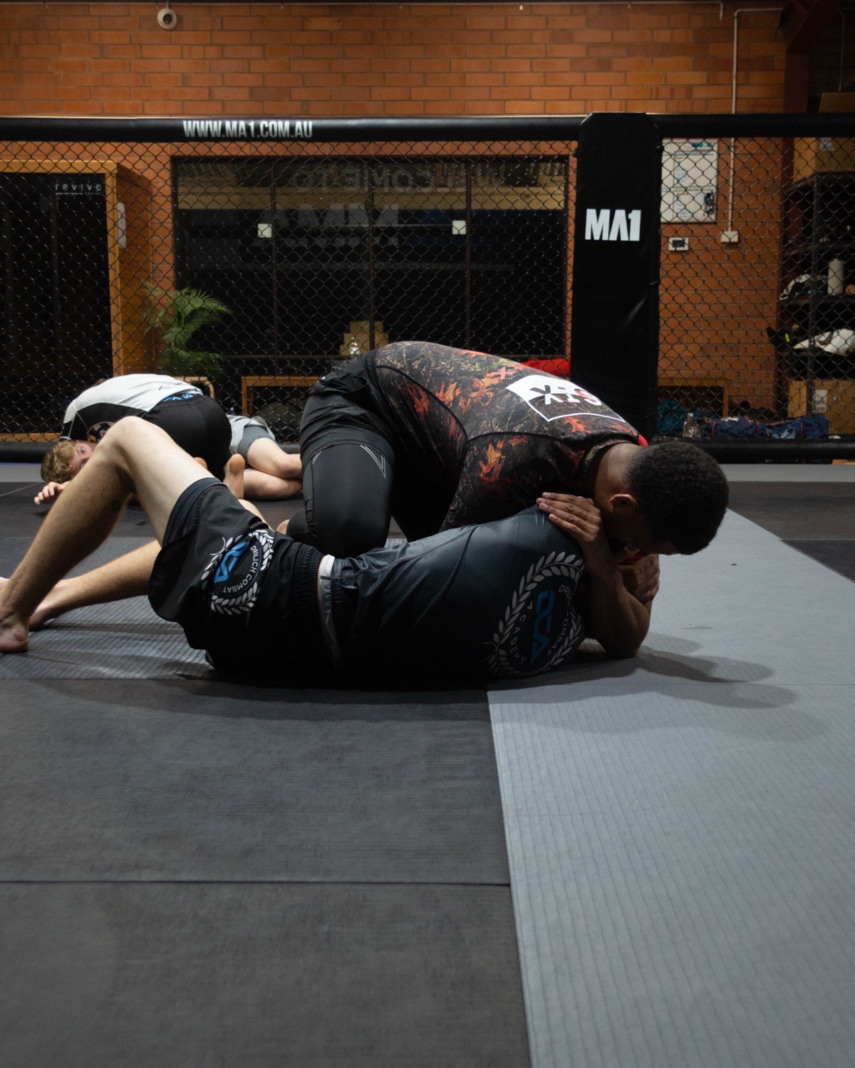 Members lined up under the Welcome to DCA MMA banner