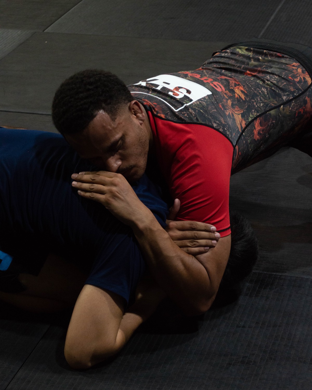 A member working the pads in a boxing class