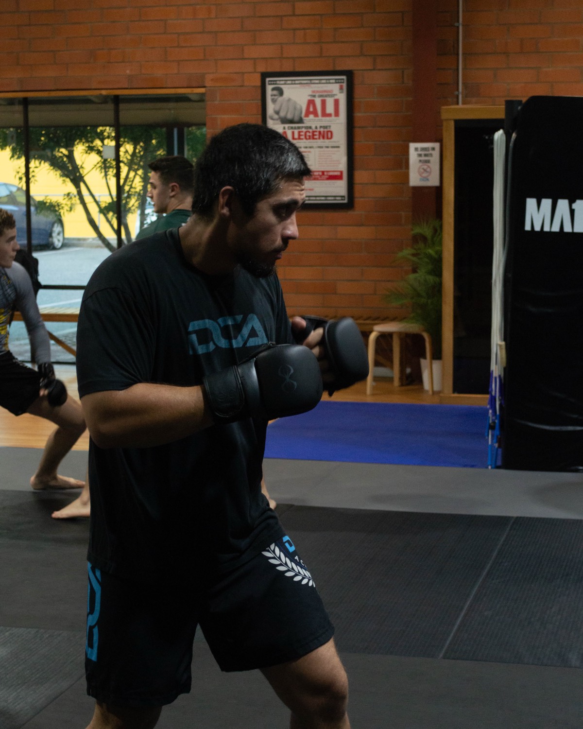 Two members rolling in a BJJ class